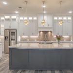White and Grey Kitchen with Quatrefoil Backsplash, Silestone Quartz Countertops, Modern Pendants, Wood Tile Flooring, and Chrome Finishes